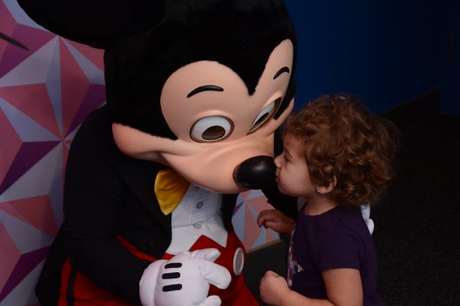 Daughter kisses Mickey Mouse
